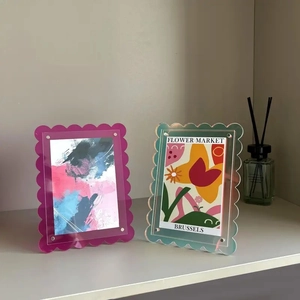 Close-up of wavy acrylic photo frames with colorful magnetic screws in a home setting