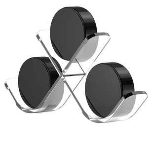 Transparent acrylic X-frame display stand showcasing three black hockey pucks on white background