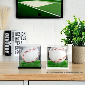 Close-up of acrylic display box for baseball with green turf base on wooden table