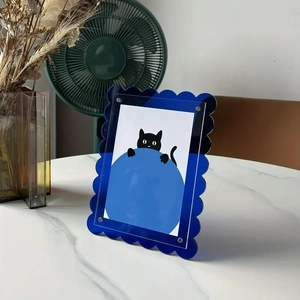 Close-up of deep blue scalloped acrylic picture frame with modern magnetic silver screws