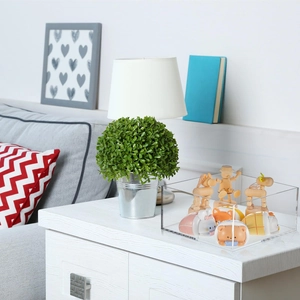 Clear acrylic display cubes on a modern nightstand showcasing toys and figurines