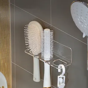 Wall-mounted acrylic bathroom organizer with three holes for combs and a bottom hook