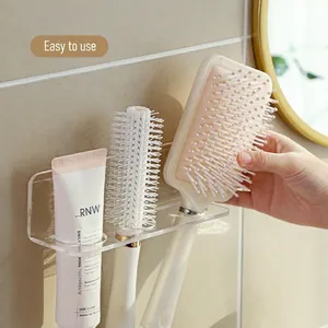Wall-mounted acrylic bathroom organizer with multiple slots for toothbrushes and toothpaste