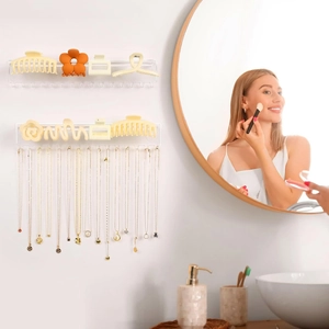 Wall-mounted clear acrylic organizer for hair clips and necklace storage with hooks