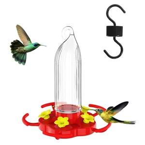 Detail of hanging pumpkin hummingbird feeder with red base, yellow flowers and S-hook