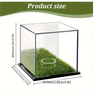 Clear acrylic golf ball display case with a green grass base and dimensions labels