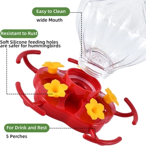 Detail view of pumpkin hummingbird feeder showing silicone ports and wide mouth bottle
