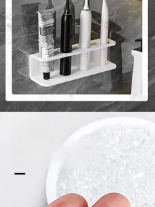 Close-up of white acrylic wall-mounted holder with 4 slots on marble tile background