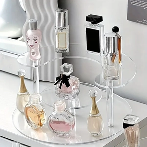 Clear acrylic tiered display stand for perfume and collectibles with round risers