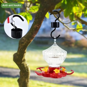 Black anti-ant hook with water moat for hanging hummingbird feeders on garden branches