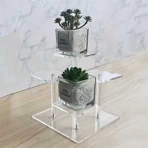 Detail view of transparent 3-tier acrylic display riser for perfumes and collectibles