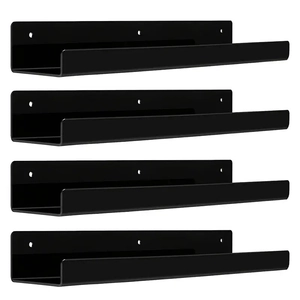 Detailed view of four black U-shaped floating shelves with wall mounting holes and matte finish
