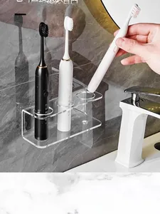 Close-up of wall-mounted clear acrylic electric toothbrush holder with 3-hole design