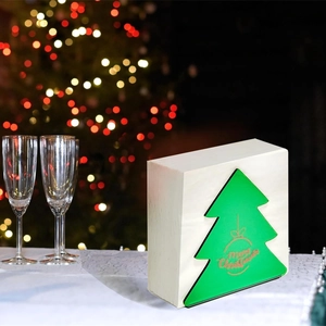 White wooden Christmas tree napkin holder with Merry Christmas text on festive table