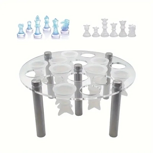 Macro view of clear acrylic chess piece mold holder and finished resin chess figures