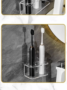 Macro detail of wall-mounted clear acrylic electric toothbrush holder for two units