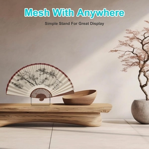 Close-up of a clear acrylic folding fan display stand on a minimalist wooden bench