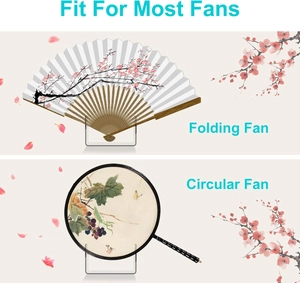 Clear acrylic display stands holding a floral folding fan and a circular grape pattern fan