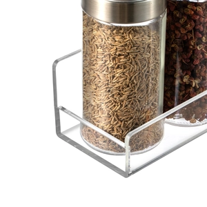 Detail showing transparent acrylic shelf with glass storage jars and stainless steel lids