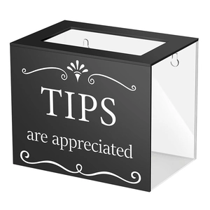 Macro view of black acrylic tip box with TIPS are appreciated text and coin slot