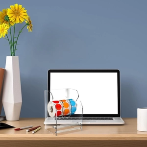 Acrylic 3-slot sticker dispenser roll holder with colorful labels on a desktop