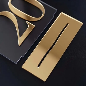 Close-up of golden mirror acrylic arch table number 20 with premium reflective surface