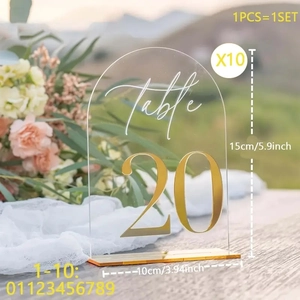 Close-up of arched acrylic table number 20 with gold mirror base for wedding decor