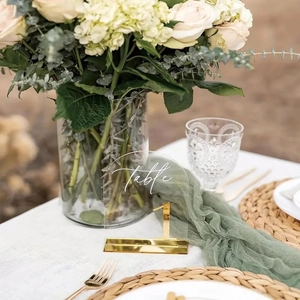 Detail of 5x7 inch arched acrylic wedding table number with gold mirror base and floral font