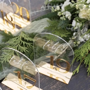 Golden arch acrylic wedding table numbers with clear stand for elegant reception decor