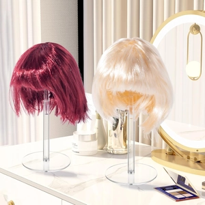 Adjustable acrylic wig stand featuring wine red and platinum blonde bob wigs on vanity
