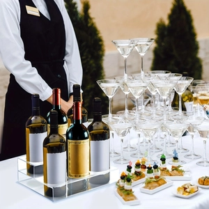 Macro detail of a 2-tier clear acrylic tiered display rack for wine and syrup bottles