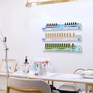 Set of three floating iridescent acrylic shelves displaying cosmetics on a white wall
