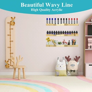 Detail of three-piece amber acrylic wavy floating wall shelves for kids room storage