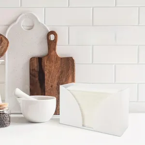 White frosted acrylic napkin holder with large curved opening on a kitchen countertop