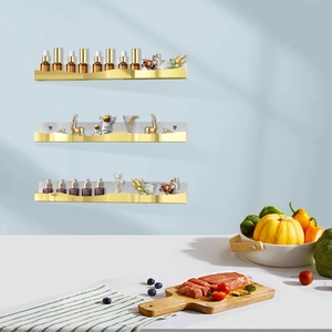 Three-piece gold wave floating shelves for cosmetics and nail polish storage on wall
