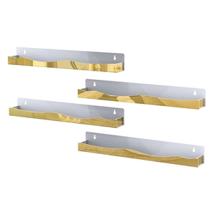 Close-up of four gold floating shelves with elegant wavy edges and white wall mounts