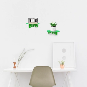 Detail of creative neon green slime-shaped floating wall shelves for small speakers