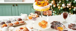 Detailed view of a 4-tier round acrylic cupcake stand displaying festive party desserts