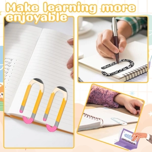 Detail view of pencil-shaped acrylic bookmarks and paper clips on notebooks