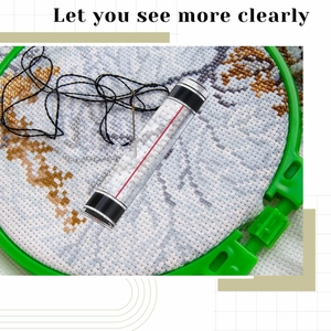 Detail of a 6-inch acrylic bar magnifier with a red guidance line over embroidery fabric