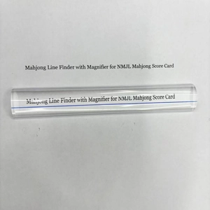 Close-up of clear acrylic bar magnifier with a blue guide line for reading small text
