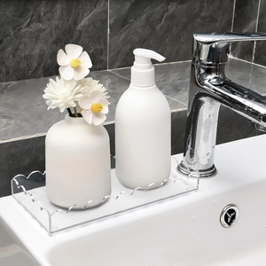 Macro view of transparent acrylic bathroom tray with wave edges for soap dispenser