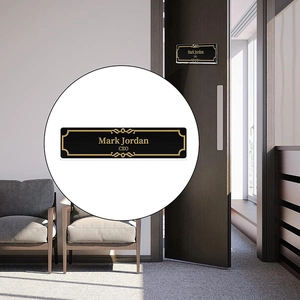 Close-up of customized black and gold acrylic office nameplate for CEO Mark Jordan