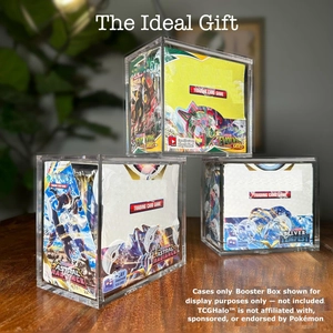 Three-tier stack of clear acrylic booster box protectors on a wooden desk
