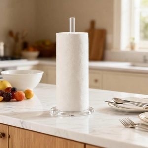 Close-up of clear acrylic kitchen towel holder with a paper roll on marble surface