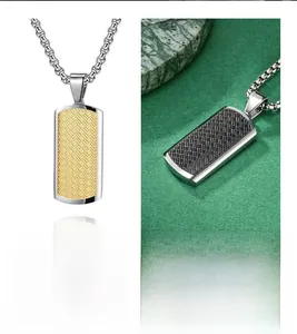 Macro detail of bicolored stainless steel pendant with textured woven grid pattern