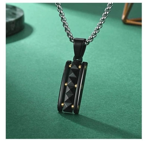 Macro detail of punk pyramid pendant with gold studs on dark leather background