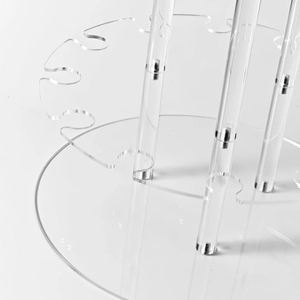 Detailed view of high-transparency acrylic display stand with circular base for glasses