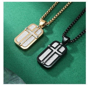 Detailed view of black and gold cross military dog tag necklaces with brushed texture