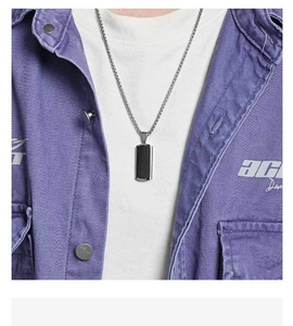 Close-up of men's rectangle pendant with black carbon fiber inlay and steel chain